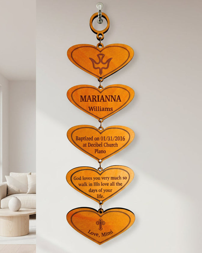 A personalized engraved wooden plaque with multiple heart-shaped cut-outs, each with a different engraving, hanging together.