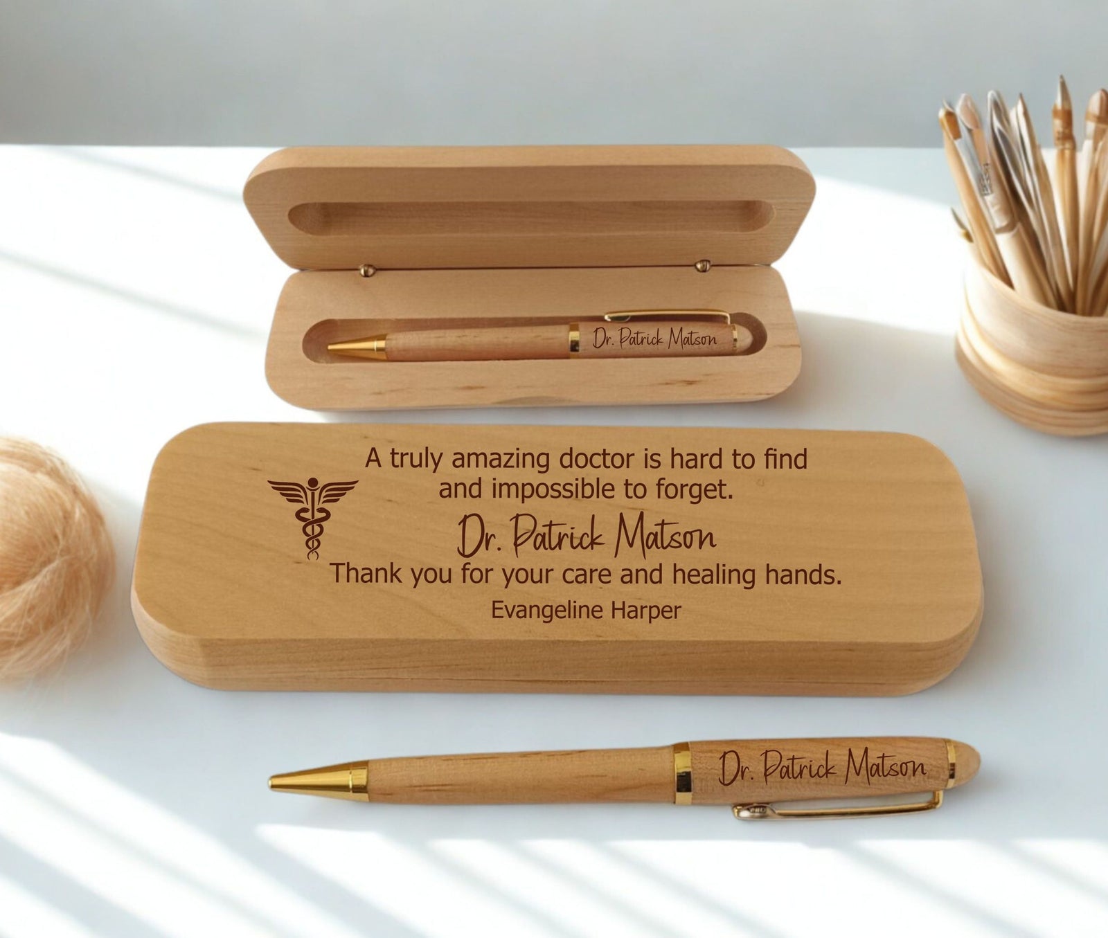 Personalized wooden pen gift set with engraved text and a matching wooden presentation box, shown on a white surface with soft natural shadows.