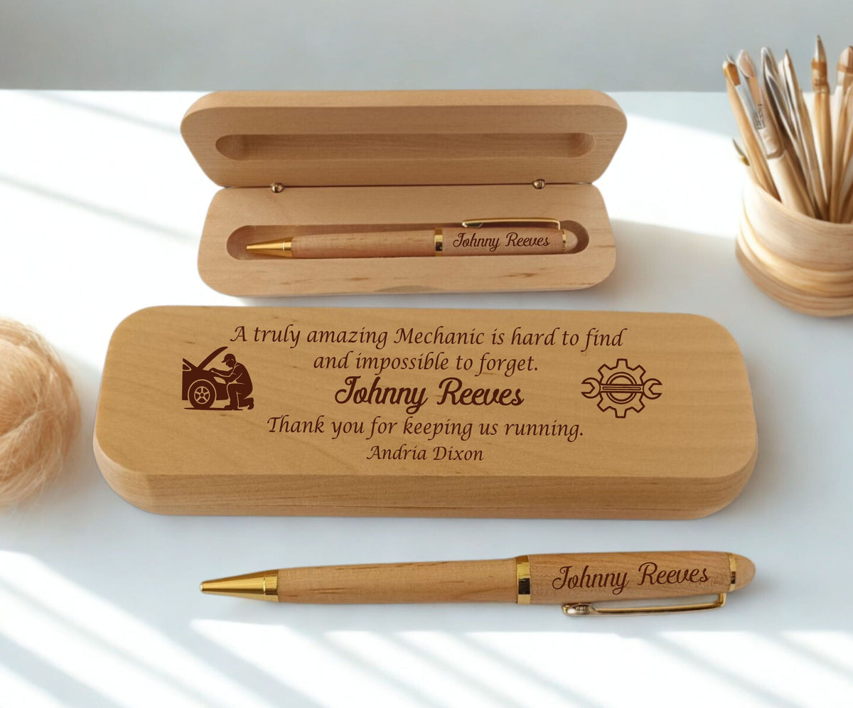 A personalized wooden pen gift set with a matching engraved wooden case, shown on a white surface with soft natural shadows. The set includes an open wooden case with a wooden pen inside, a closed engraved wooden case with a quote and car graphic, and another wooden pen lying in front.