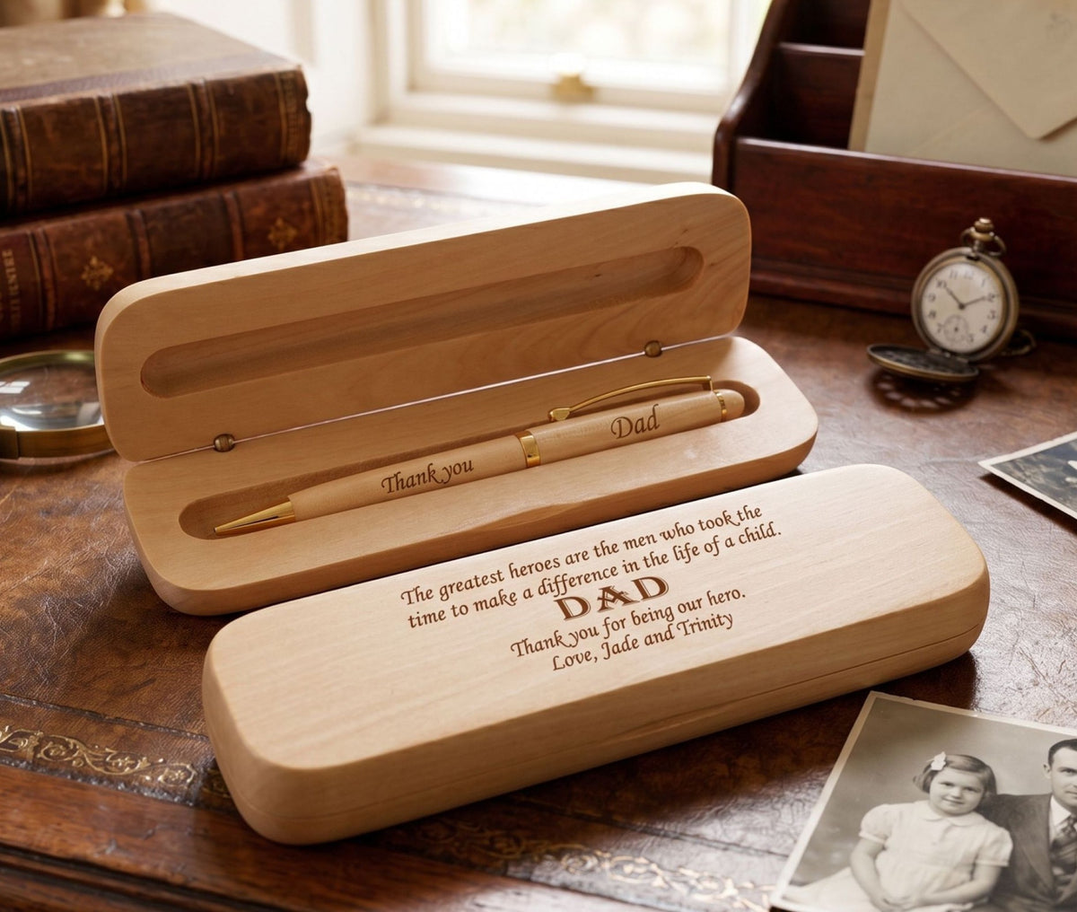A personalized wooden pen set with engraved text, presented in a matching wooden case, with an additional gift box. The text on the pen and case reads 'DAD' and includes a personal message.