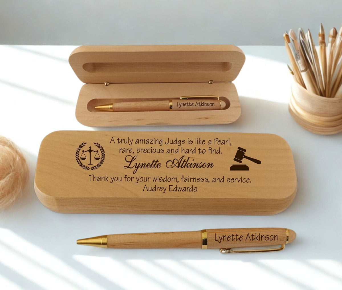 Personalized wooden keepsake box set with a pen, shown open and closed on a white surface with soft sunlight and shadows. The engraved text and seals are visible on the wooden box and pen.
