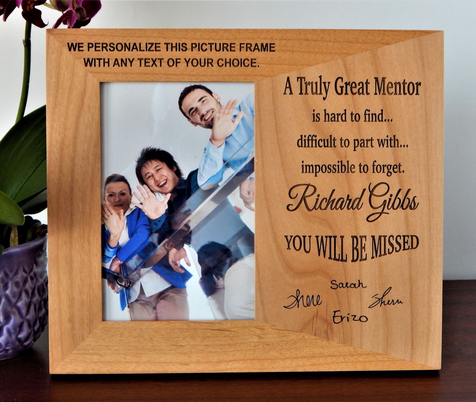 A personalized engraved wooden picture frame with a photo and textual tribute to a mentor, displayed on a tabletop.
