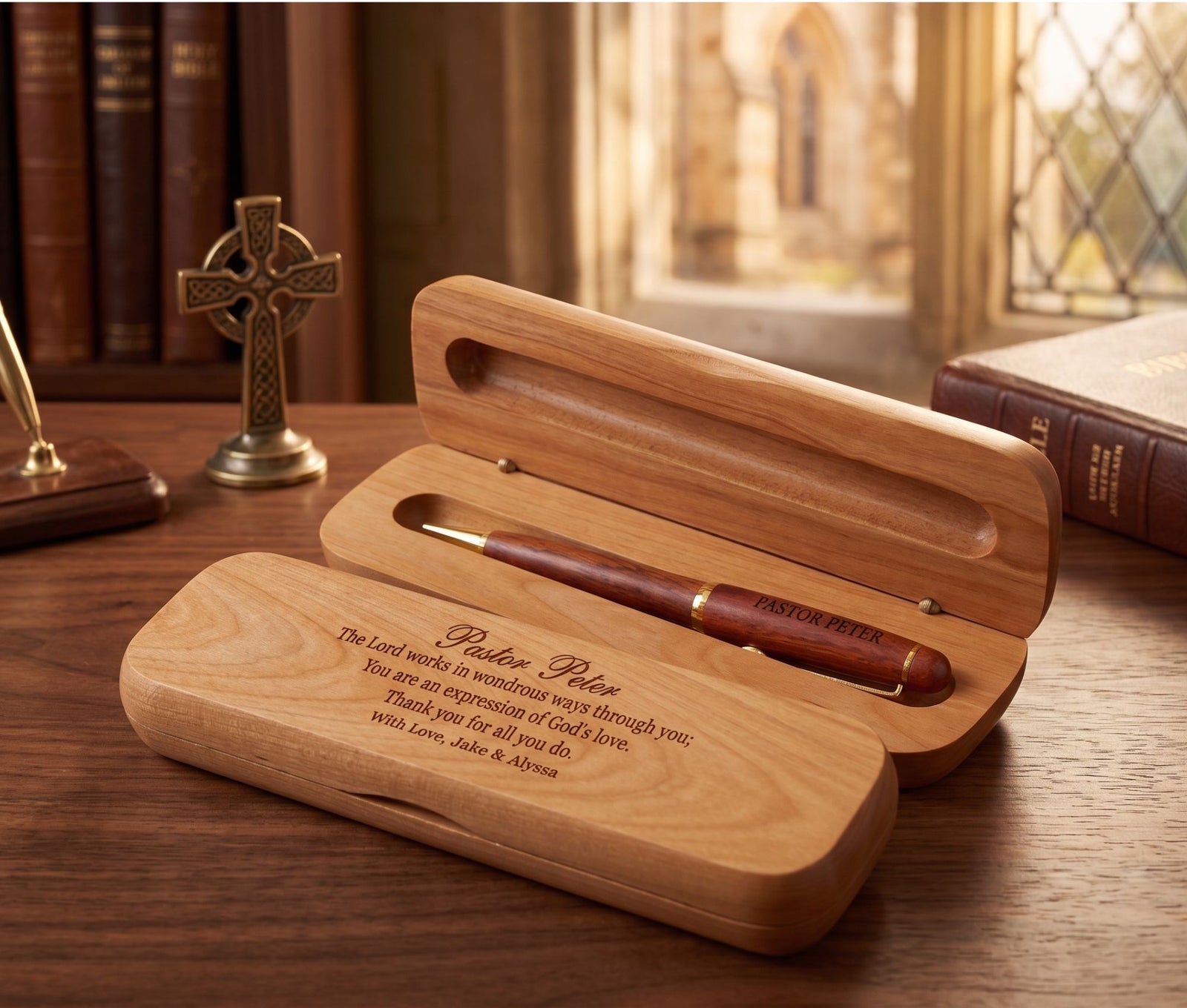 A personalized wooden pen gift set with a matching engraved wooden case, displayed on a wooden table in a warm, book-filled room setting.