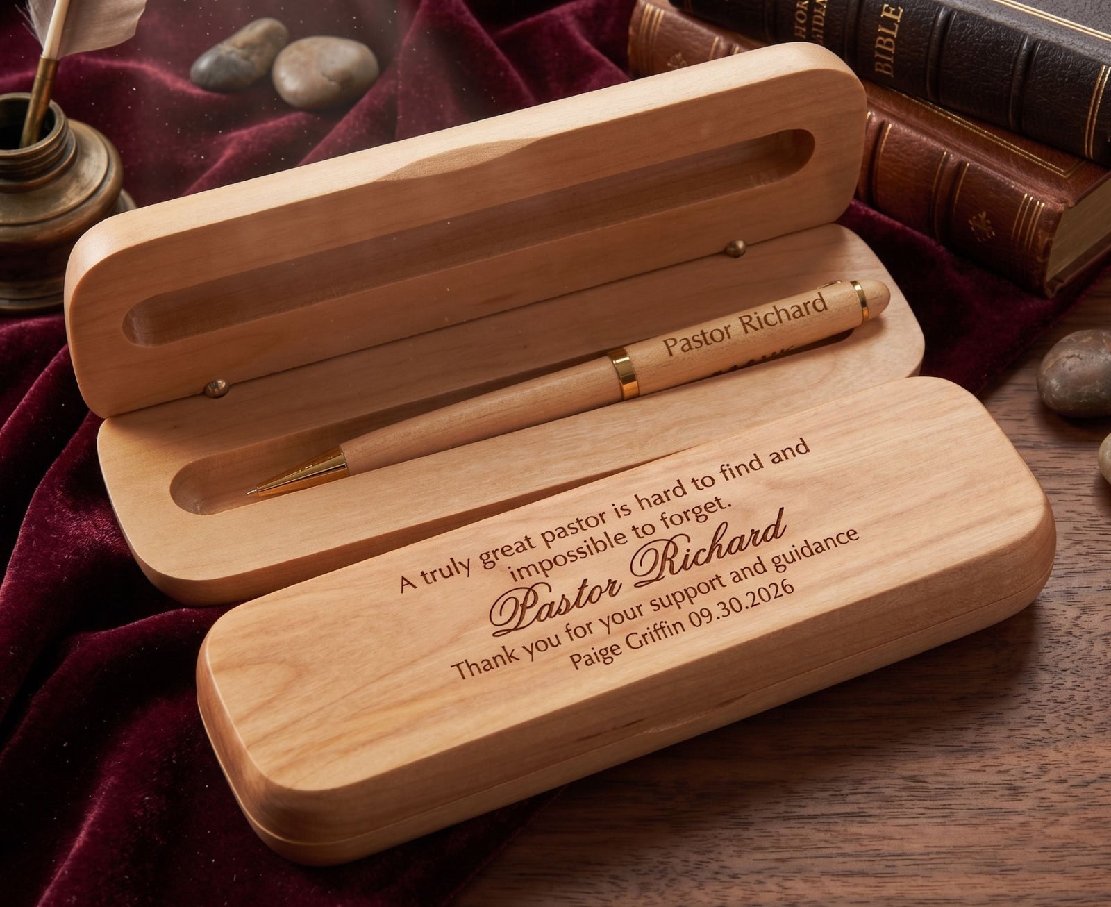 Personalized wooden keepsake box set with a pen, shown open on a dark red velvet cloth with books in the background. The boxes are engraved with a message for Pastor Richard, and the pen has a gold accent.
