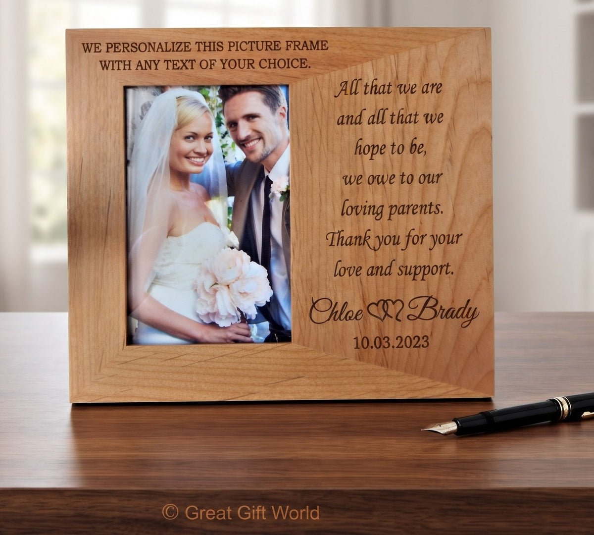A personalized wooden picture frame with engraved text, shown standing on a wooden table. The frame has a photo of a bride and groom on the left and a message to parents on the right.