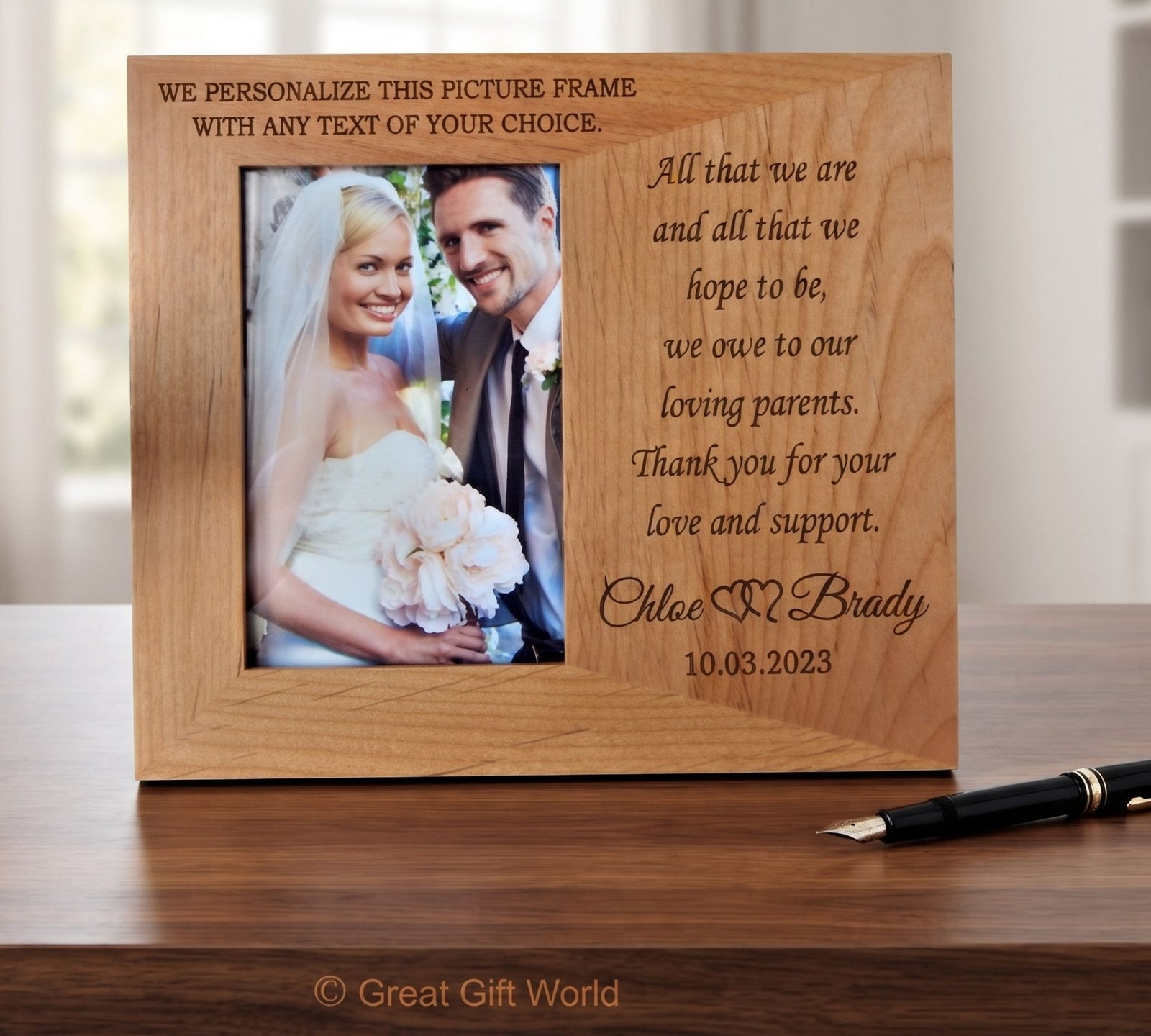 A personalized wooden picture frame with engraved text, shown standing on a wooden table. The frame has a photo of a bride and groom on the left and a message to parents on the right.