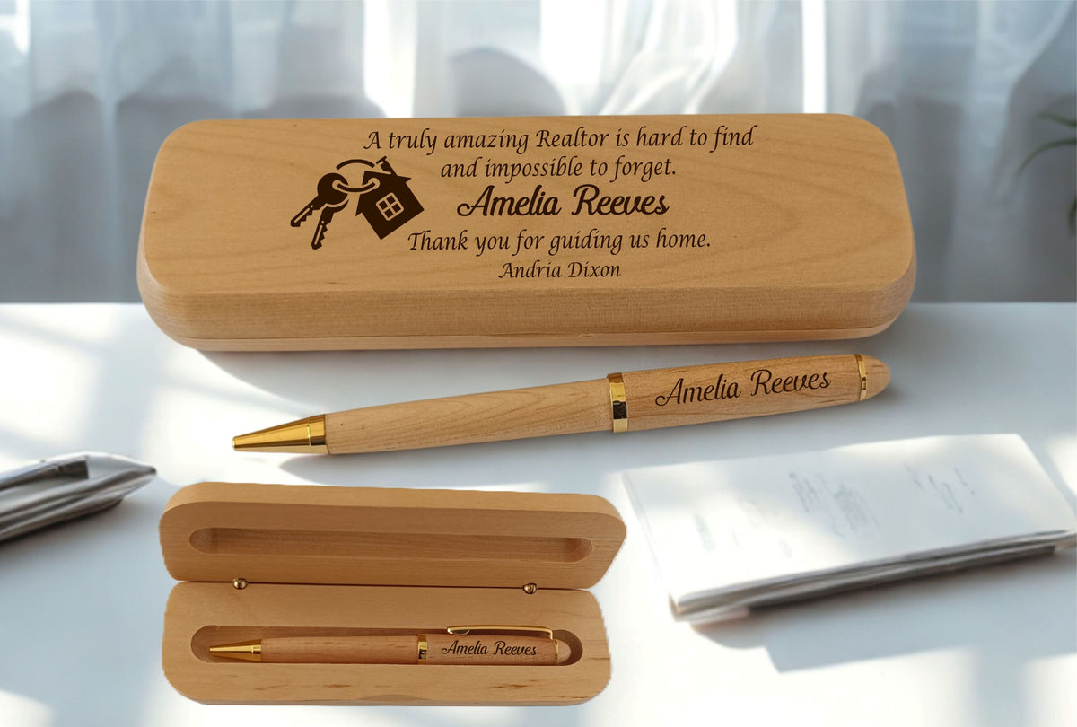 Personalized engraved wood pen and case set for a realtor, laser engraved with the name  and the message 'A truly amazing Realtor is hard to find and impossible to forget. Thank you for guiding us home.' with a house and keys icon, shown with the pen resting beside the closed case and displayed inside the open case.