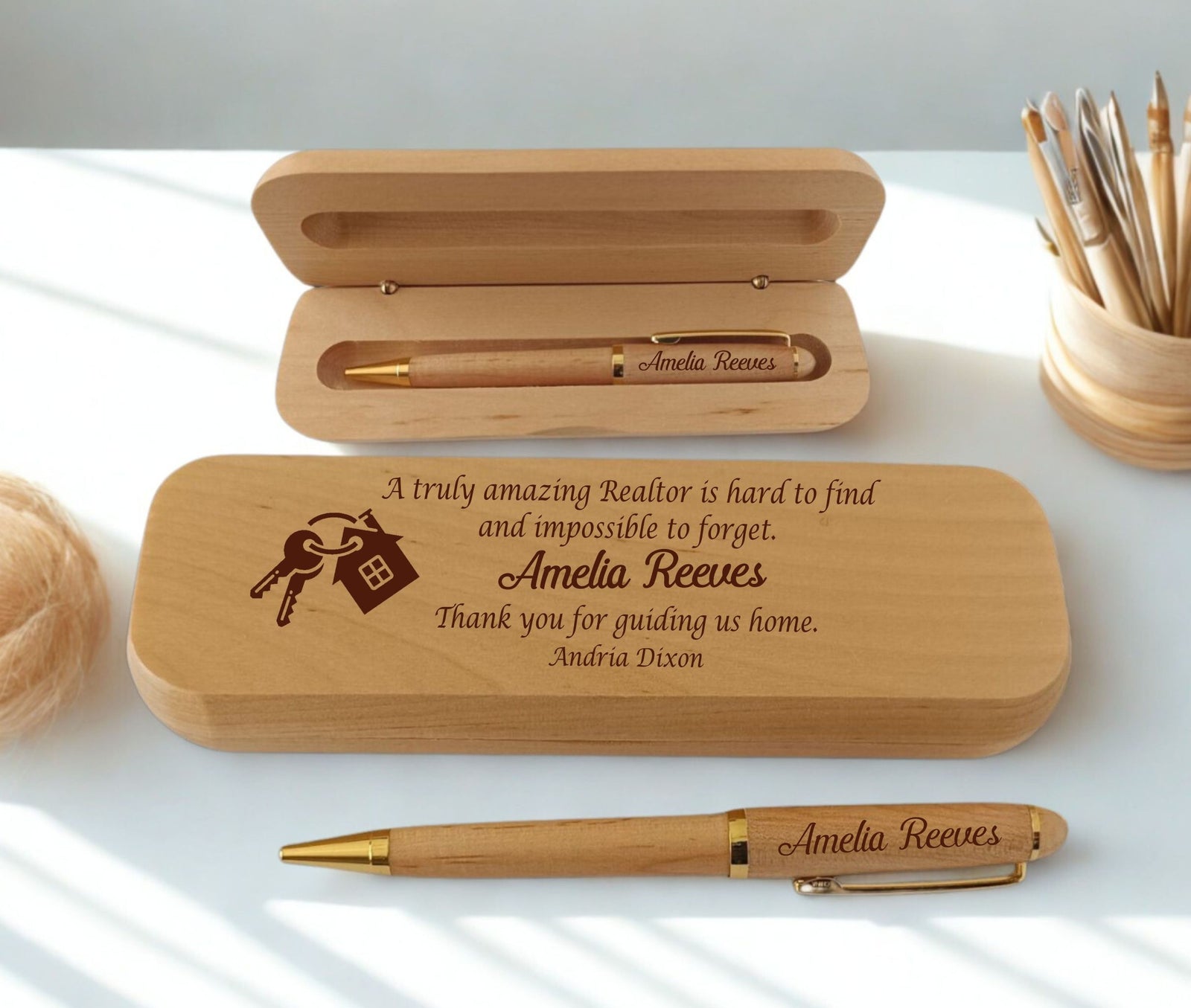 Personalized wooden pen gift set with engraved text and key graphic, shown open and closed on a white surface with a pencil cup in the background.